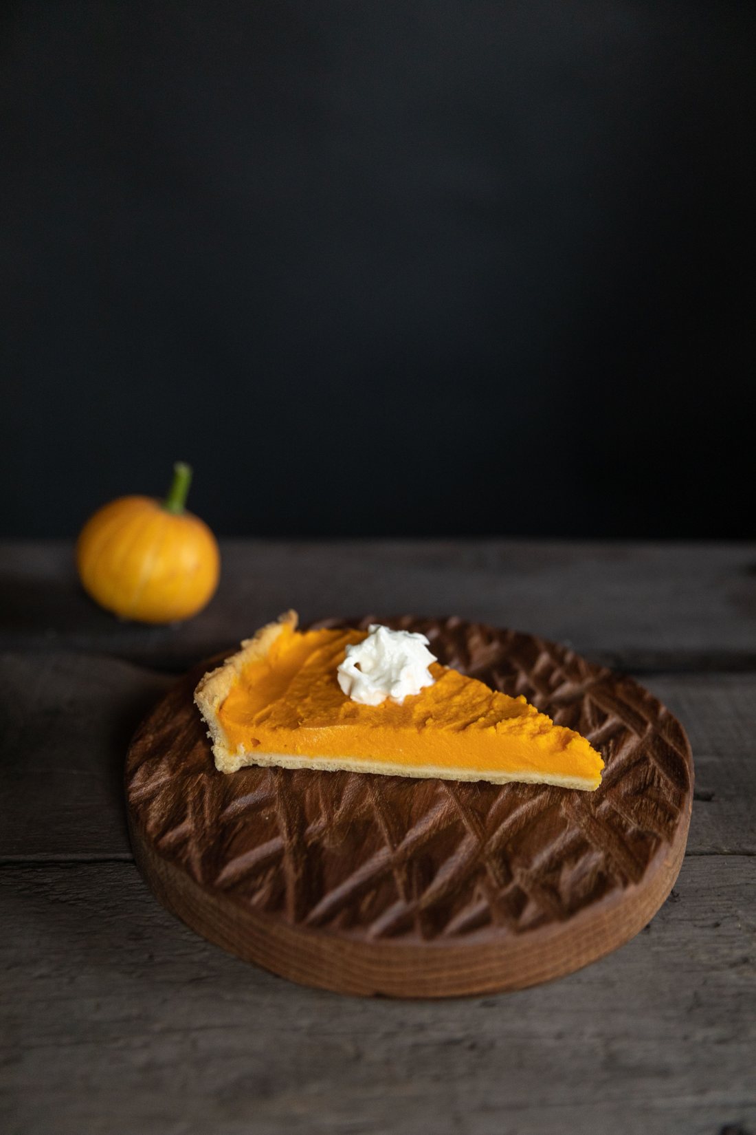 A slice of pumpkin pie with whipped cream
